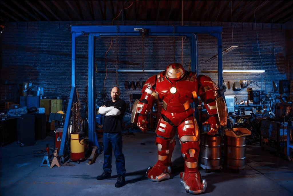 Guy and the Hulkbuster in a garage